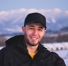 man in black hat smiling