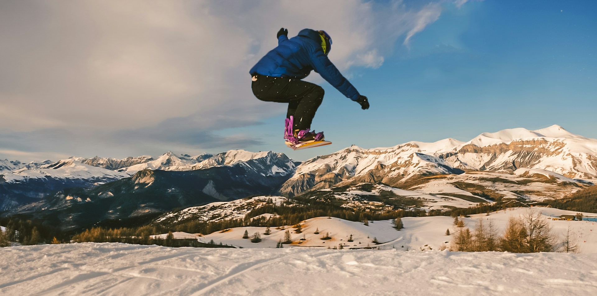 A snowboarder doing a jump in the air
