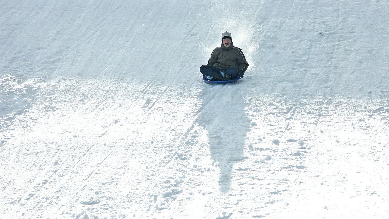 person going down slope on tobogan